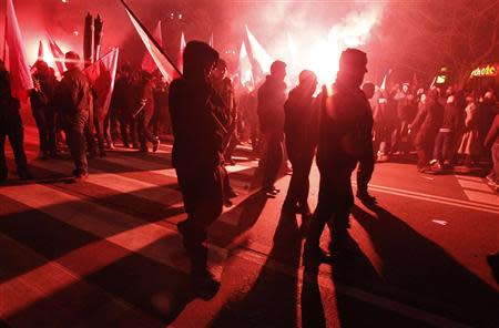 Far-right protesters walk during the annual far-right march, which coincides with Poland's National Independence Day in Warsaw November 11, 2013. REUTERS/Kacper Pempel