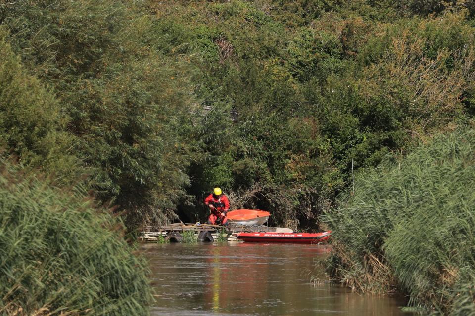 A member of Kent Search and Rescue searches a section of the River Stour (PA)