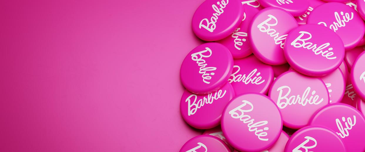 Barbie logos on a heap on a table