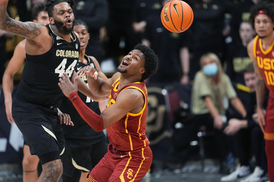 Southern California guard Bronny James, right, loses control of the ball as Colorado center Eddie Lampkin Jr. defends during the second half of an NCAA college basketball game Saturday, Jan. 13, 2024, in Boulder, Colo. (AP Photo/David Zalubowski)