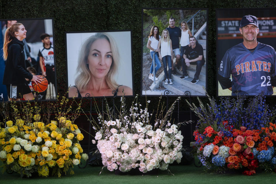 Flowers and photos honor members of the Altobelli family outside Angel Stadium, Monday, Feb. 10, 2020, in Anaheim, Calif. Coach John Altobelli, 56, far right, his wife, Keri, 43, second from left, and his daughter Alyssa, 13, left, died in a helicopter crash on Jan. 26 in Calabasas. (AP Photo/Damian Dovarganes)