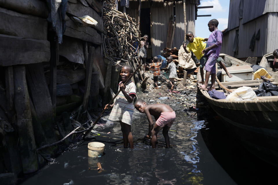 Children play in filthy water surrounded by garbage in Nigeria's economic capital Lagos' floating slum of Makoko, Monday, March. 20, 2023. March 22 is World Water Day, established by the United Nations and marked annually since 1993 to raise awareness about access to clean water and sanitation. (AP Photo/Sunday Alamba)