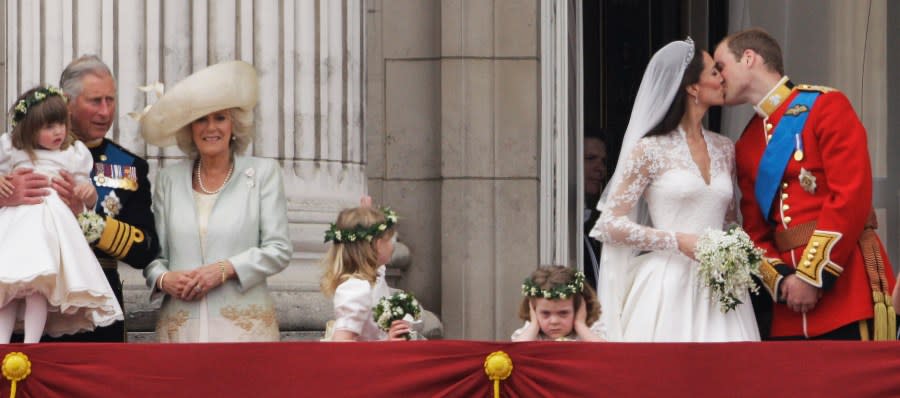 FILE – Britain’s Prince Charles and Camilla, Duchess of Cornwall watch as Britain’s Prince William kisses his wife Kate, Duchess of Cambridge on the balcony of Buckingham Palace after the Royal Wedding in London Friday, April, 29, 2011. (AP Photo/Matt Dunham, File)