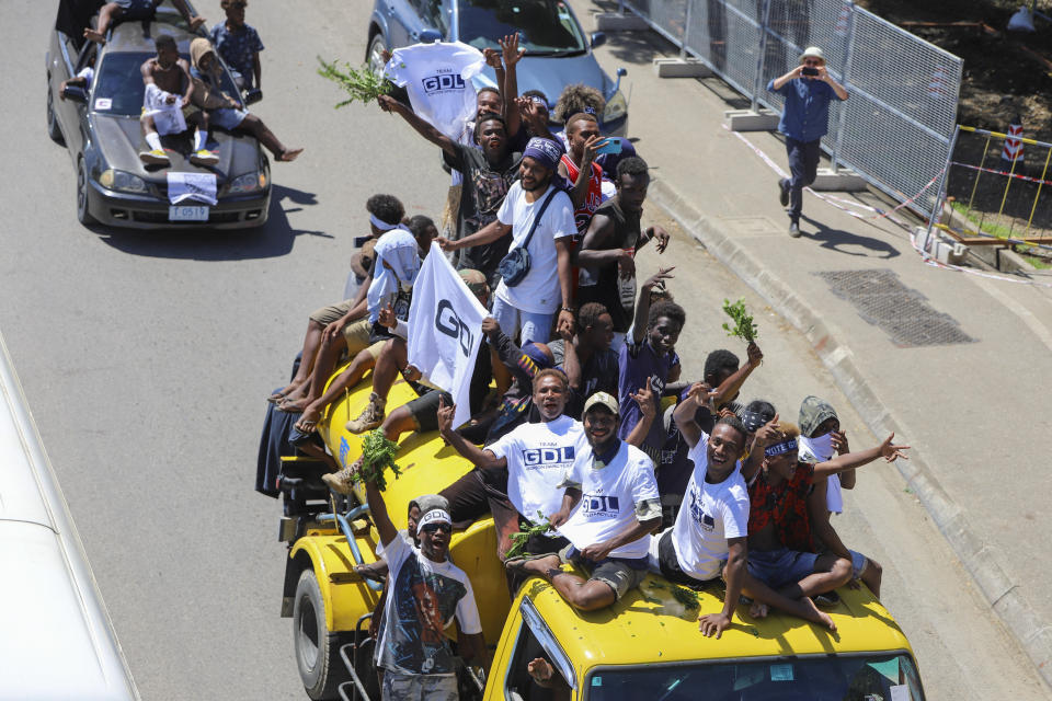 Locals react as they participate in a candidates parade in the capital Honiara, Solomon Islands, Monday, April 15, 2024. The country in which China has gained most influence in the South Pacific, Solomon Islands, goes to the polls on Wednesday in an election that could shape the region's future. (AP Photo/Charley Priringi)