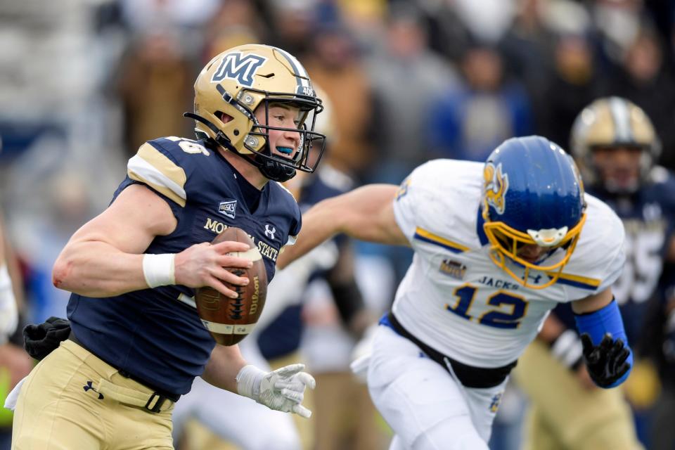 Montana State Bobcats quarterback Tommy Mellott (16) runs with the ball as South Dakota State Jackrabbits linebacker Logan Backhaus (12) gives chase during an NCAA college football game in the semifinals of the FCS playoffs, Saturday, Dec. 18, 2021, in Bozeman, Mont. (AP Photo/Tommy Martino)