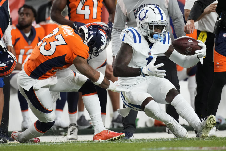 Indianapolis Colts wide receiver Parris Campbell (1) makes a catch as Denver Broncos cornerback Ronald Darby (23) defends during the first half of an NFL football game, Thursday, Oct. 6, 2022, in Denver. (AP Photo/David Zalubowski)