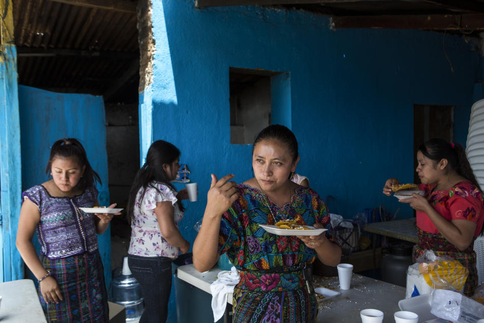 After a political rally of the National Unity of Hope party, women eat and drink near the facilities where the rally was held in San Martin Jilotepeque, Guatemala, Sunday, August 4, 2019. President Jimmy Morales on July 6 signed a pact with the U.S. that would require migrants, who are largely Salvadorans and Hondurans, to request asylum in Guatemala if they cross through the country, as they must if traveling land routes, before reaching the U.S. border. But still the fear of other migrants persists as Guatemalan head for Presidential elections on Sunday. (AP Photo/Oliver de Ros)