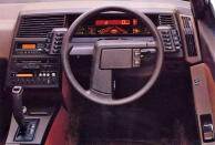 <p>The XT was the turbocharged wedge that time forgot. Its dashboard may have been created with cheap plastic, but what made it so glorious was its switch gear, digital display and three-spoke steering wheel. Mounting switches to the dashboard simply wasn’t good enough for Subaru, so the XT received two wing-like control units that were placed just behind the steering wheel. When switched on, the 3D display was oddly mesmerising with its <strong>backlit orange and red colour combination</strong>.</p>