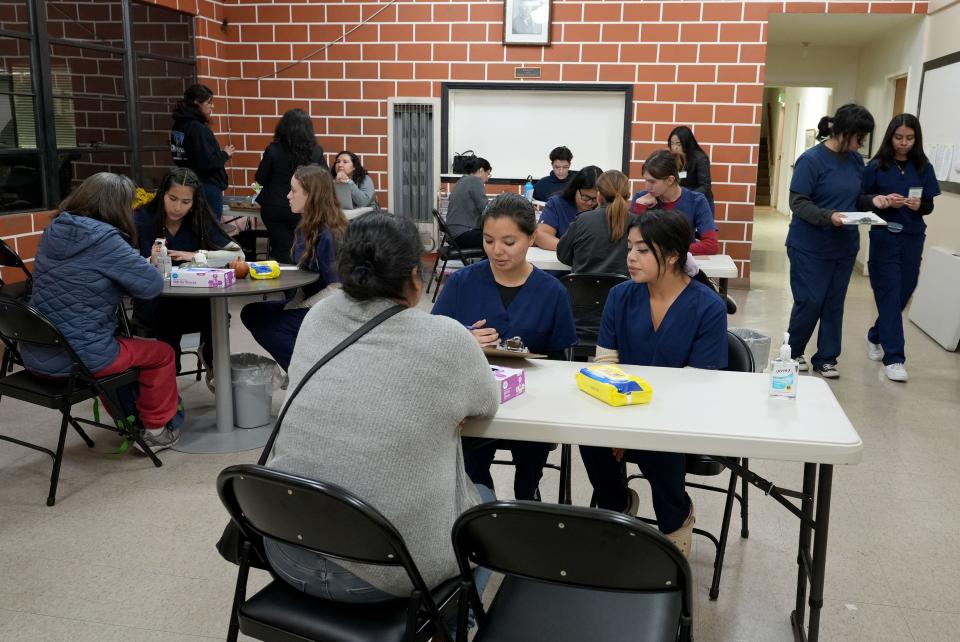 Students from Santa Paula High School interview patients about their health at the Westminster Free Clinic in Santa Paula on Thursday. The free health clinic includes medical career training for high school students.