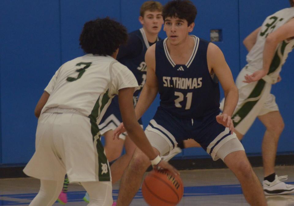 St. Thomas's Will Mollica guards Dover's Yavier Morales during Thursday's championship game of the 12th annual Oyster River Holiday Classic.