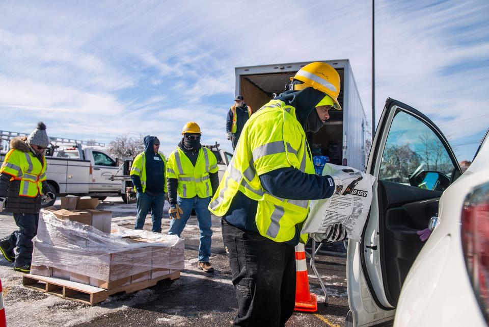 Derrick Hunter from Central Hudson explains how to safely use dry ice to a driver in line at the dry ice distribution site in the Town of Ulster, NY on Sunday, February 6, 2022. Many residents are still without power after Friday's storm.