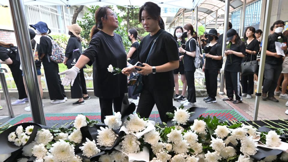Mourners lay flowers in front of a memorial altar for an elementary school teacher who died in an apparent suicide in July at an elementary school in Seoul on September 4, 2023.  - Jung Yeon-je/AFP/Getty Images