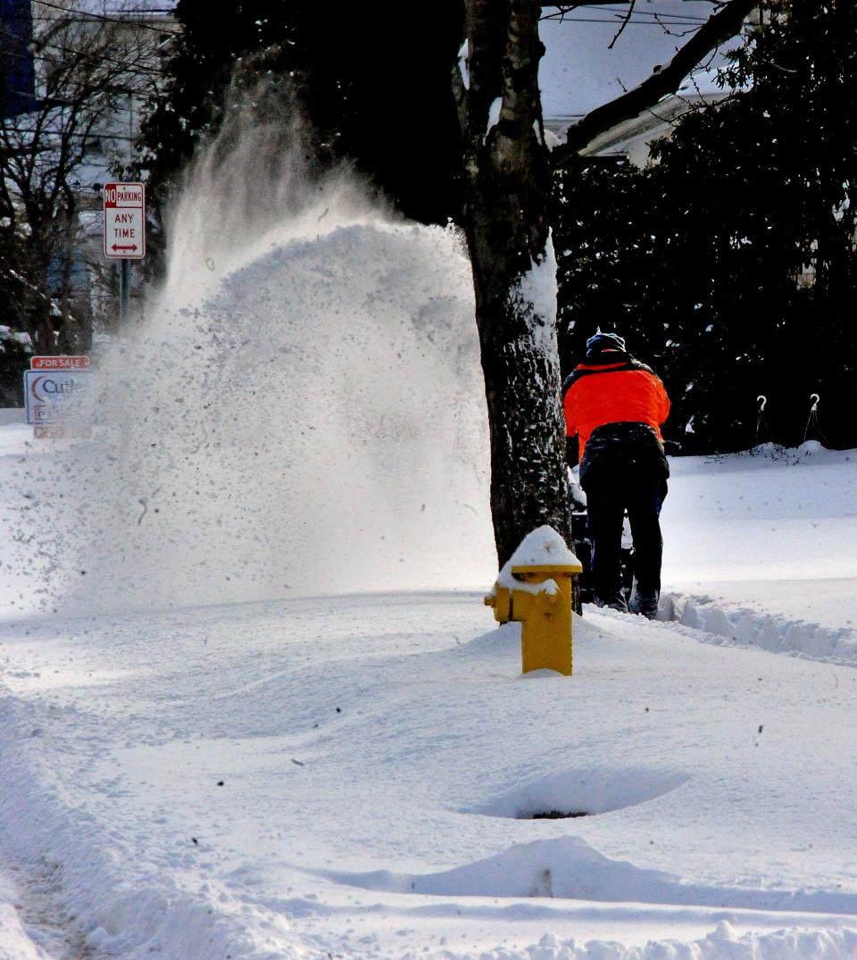 Snow was flying as a man cleared the sidewalk in Wooster on Monday morning.