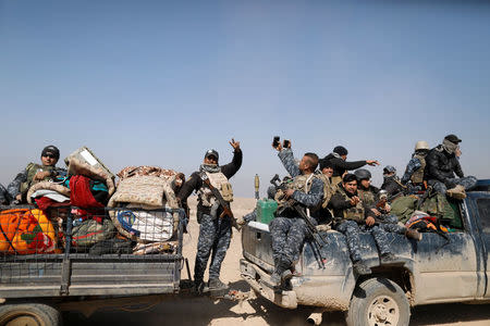 Federal police members react as they arrive in Albu Saif, which was recently retaken by Iraqi military forces, south of Mosul, Iraq February 22, 2017. REUTERS/Zohra Bensemra