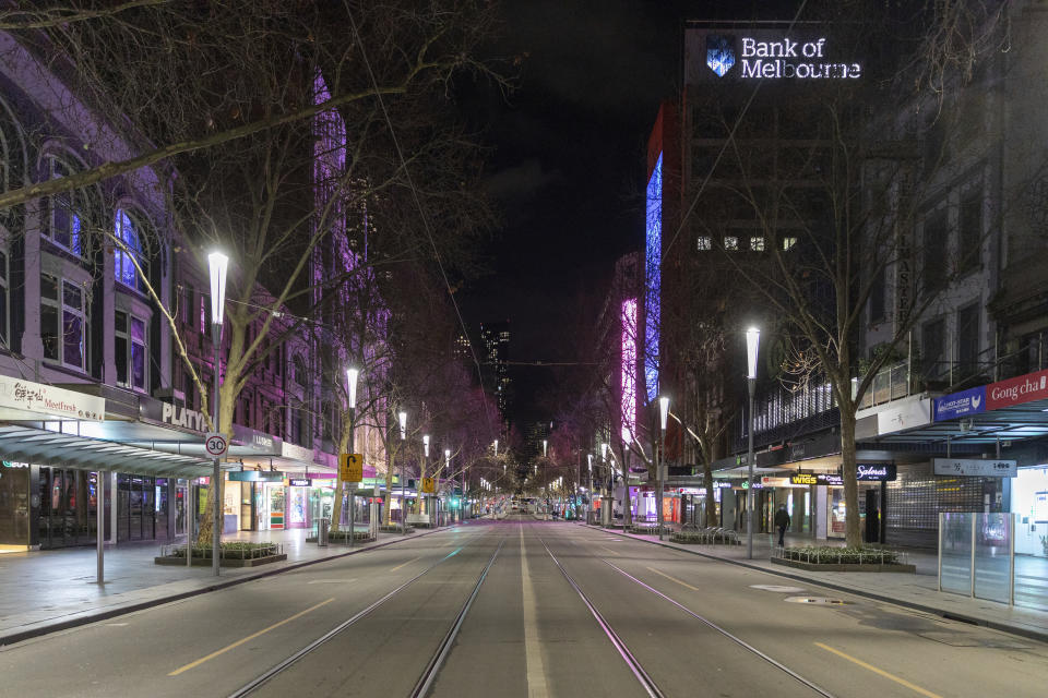FILE - In this Aug. 5, 2021, file photo, an empty Swanston Street is seen at night in the Central Business District as lockdown due to the continuing spread of COVID-19 prepares to start in Melbourne. Melbourne, the city that was once Australia’s worst COVID-19 hot spot has announced a seven-day lockdown, its fourth since the pandemic began. (AP Photo/Asanka Brendon Ratnayake, File)