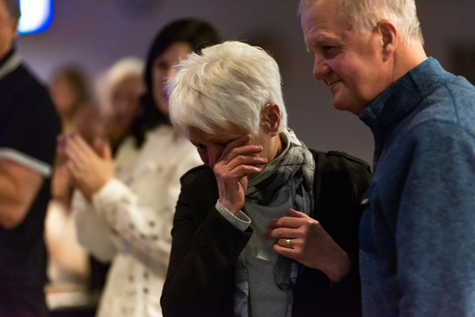 Connie Rieger wipes away tears as she and her husband, Dale, walk to the stage to accept the Frances and Gordon Spies Community Image Award at the annual Cheboygan Area Chamber of Commerce awards dinner at the Knights of Columbus on Thursday, Jan. 18, 2024.