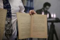 Roni Gross, curator of the Hebrew University's Albert Einstein Archive, displays original documents related to Albert Einstein's hypothesis of the existence of gravitational waves during a news conference in Jerusalem February 11, 2016. REUTERS/Ronen Zvulun