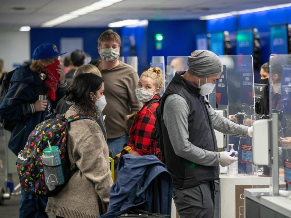 LOS ANGELES, CA - NOVEMBER 23: Travelers wearing masks get their tickets and check luggage at LAX as the Thanksgiving holiday getaway period gets underway on Monday, Nov. 23, 2020 in Los Angeles, CA. Millions of Americans are carrying on with their travel plans ahead of Thanksgiving weekend despite the CDC's urgent warnings to stay home as the number of daily cases and hospitalizations in the country continue to hit record highs. Confirmed cases in the U.S. for the disease topped 12 million on Saturday as more than 193,000 new infections were recorded in the US on Friday. This broke the previous record for the largest single-day spike on Thursday - and over 82,000 patients are now hospitalized across the country.