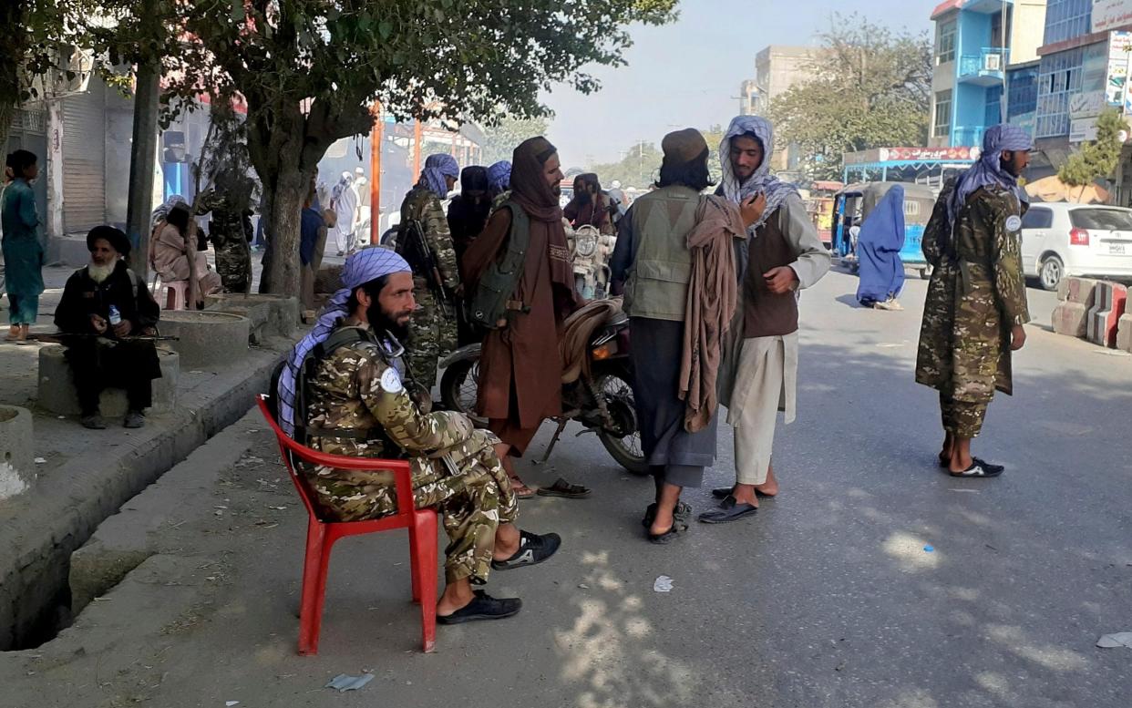 Taliban fighters stand guard at a checkpoint in Kunduz, northern Afghanistan, after the capture of the city - Abdullah Sahil/AP