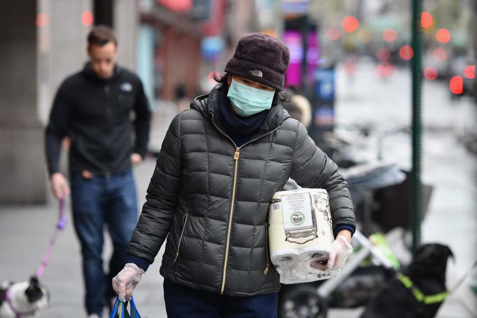 People wear masks to protect themselves from Covid-19 in the US (AFP via Getty Images)