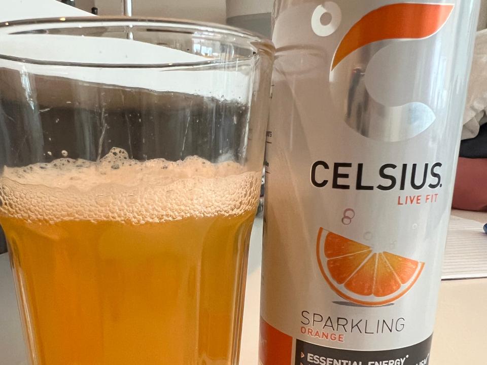 glass of celcius next to a can of celcius