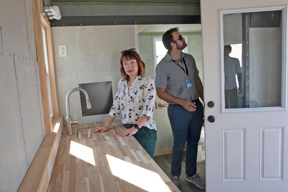 Emily Echevarria, communications director for the Council on Aging of West Florida, Blaise Moehl, resource development manager at Pensacola Habitat for Humanity, a tour of a tiny home that that the council recently purchased. The tiny homes could be an affordable option for seniors, according to the council.