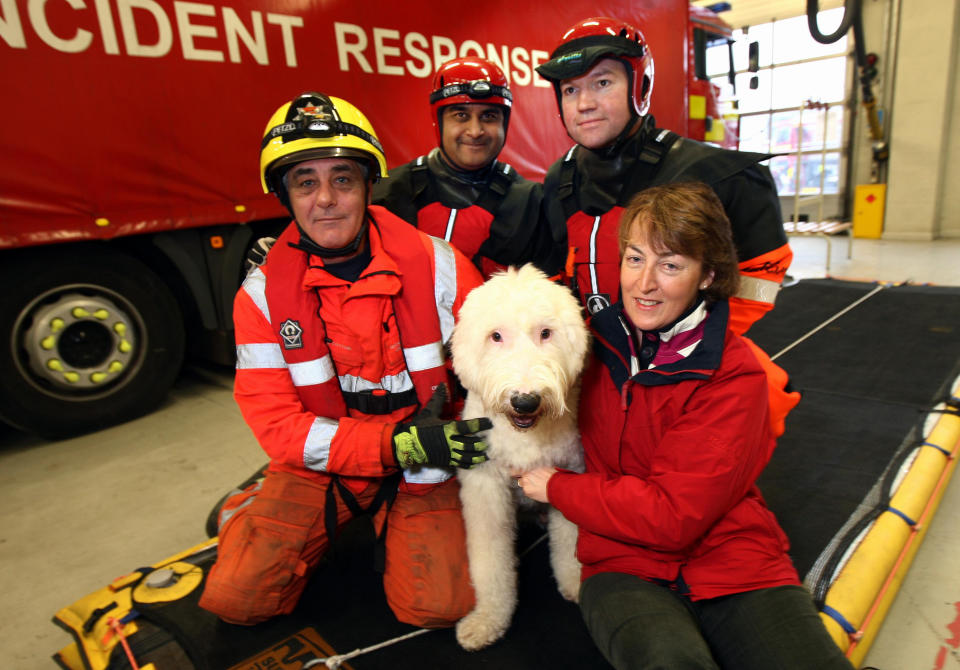 'Monty' the Old English sheepdog with owner Heather Baker (right) and the team from Leicestershire Fire and rescue today.