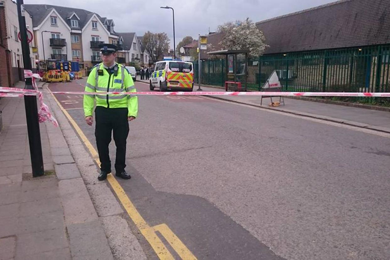 Investigation: Police at the scene of the murder in Southall