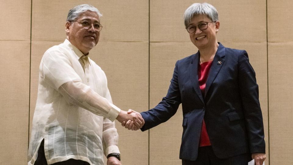Australian Foreign Minister Penny Wong, right, shakes hands with Philippine Foreign Affairs Secretary Enrique Manalo during a joint press conference at a hotel in Makati City, Philippines on Thursday May 18, 2023. (Lisa Marie David/Pool Photo via AP)