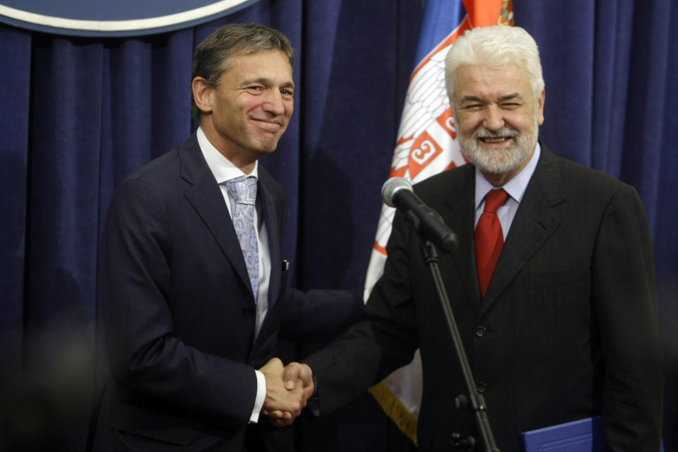 Mirko Cvetkovic, the Serbian Prime Minister, right, and the head of the EU mission in Serbia, Vincent Degert, shake hands in Belgrade, Serbia, Wednesday, Oct. 12, 2011. The EU's executive commission recommended on Wednesday that Serbia be granted the status of a candidate for membership in the bloc, but it said it would not set a date for formal accession talks until Serbia and Kosovo normalize their ties. (AP Photo/ Marko Drobnjakovic)