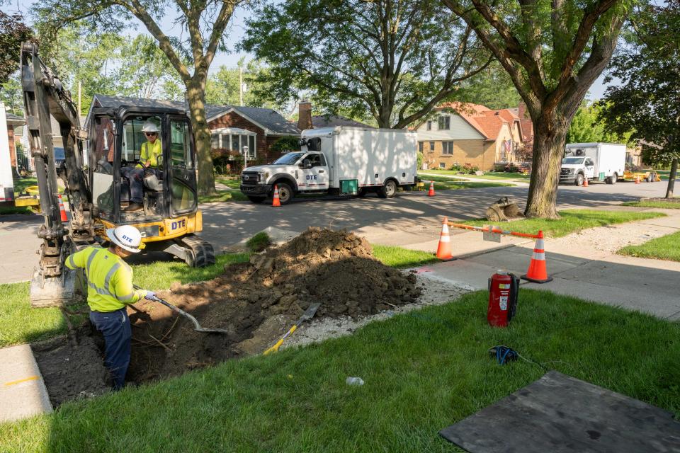 DTE Energy crews dig up the sidewalk so they can install a new gas service line in Wyandotte.