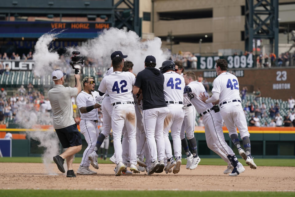 Teammates surround Detroit Tigers designated hitter Miguel Cabrera after his walk-off single during the 11th inning of a baseball game against the San Francisco Giants, Saturday, April 15, 2023, in Detroit. (AP Photo/Carlos Osorio)