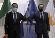 Cypriot Foreign Minister Nicos Christodoulides, right, and Italian Foreign Minister Luigi Di Maio greet each other prior to their meeting at the Foreign Ministry house in Nicosia, Cyprus, March 9, 2021. Maio is in Cyprus for one-day visit. (Yiannis Kourtoglo/Pool via AP)