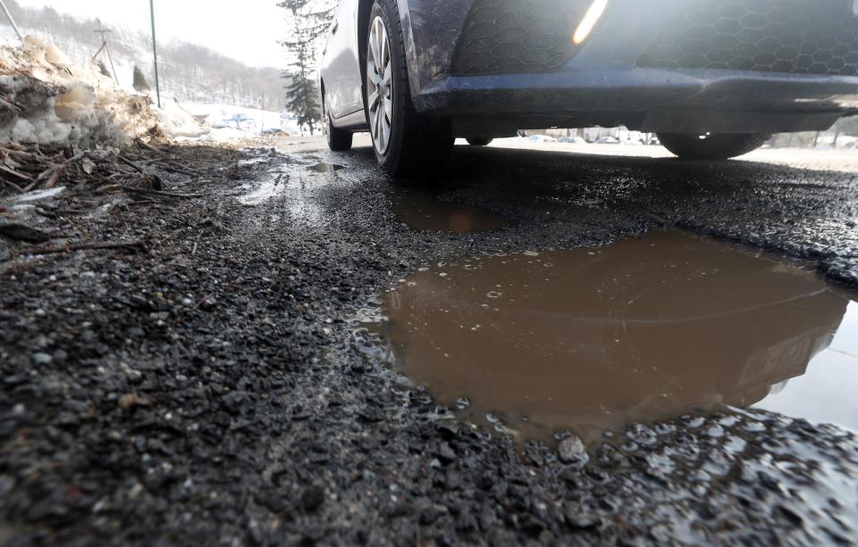 A large pothole filled with melting snow on Birch Hill Road in Patterson Jan. 25, 2022. 