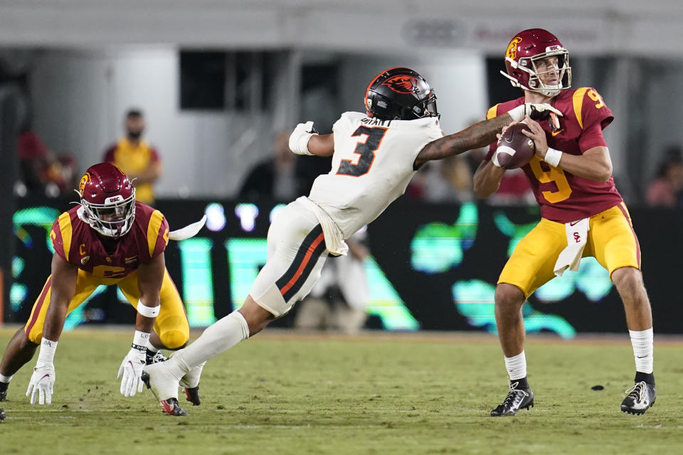 Southern California quarterback Kedon Slovis is pressured by Oregon State defensive back Jaydon Grant (3) during the first half of an NCAA college football game Saturday, Sept. 25, 2021, in Los Angeles. (AP Photo/Marcio Jose Sanchez)