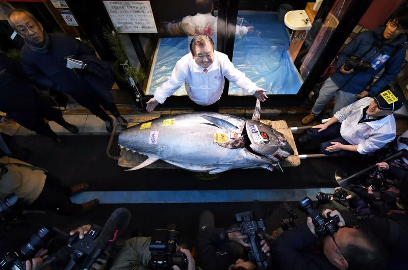 Kiyoshi Kimura, president of Kiyomura Corp., poses with a bluefin tuna in Tokyo