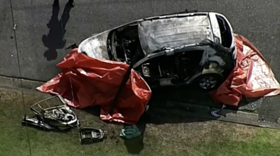 The burnt car at the scene in Camp Hill, Brisbane. Source: Reuters
