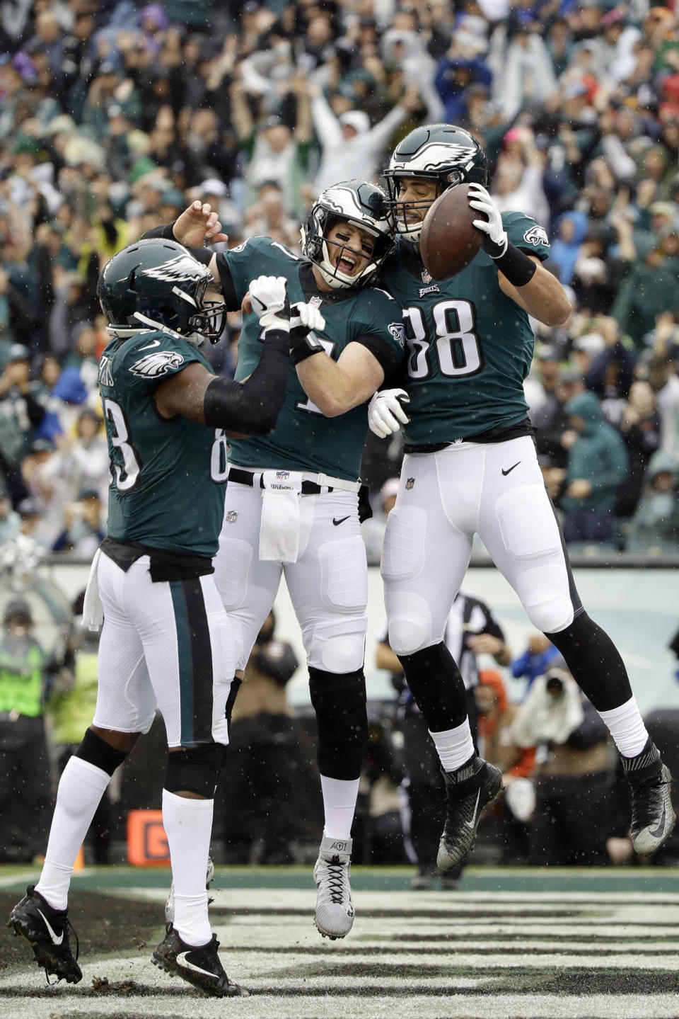 Philadelphia Eagles' Dallas Goedert, from right, Carson Wentz and Josh Perkins celebrate after Goedert's touchdown during the first half of an NFL football game against the Indianapolis Colts, Sunday, Sept. 23, 2018, in Philadelphia. (AP Photo/Matt Rourke)