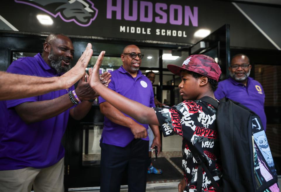 Students are greeted with high-fives at the entrance to Hudson Middle School in the California neighborhood on the first day of classes Wednesday morning, Aug. 9, 2023. 