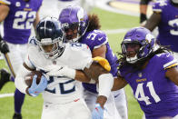 Tennessee Titans running back Derrick Henry (22) is tackled by Minnesota Vikings middle linebacker Eric Kendricks (54) and free safety Anthony Harris (41) during the first half of an NFL football game, Sunday, Sept. 27, 2020, in Minneapolis. (AP Photo/Bruce Kluckhohn)