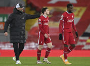 Liverpool's manager Jurgen Klopp, left walks off the pitch with his players Liverpool's Andrew Robertson, centre and Liverpool's Divock Origi during the English Premier League soccer match between Liverpool and Everton at Anfield in Liverpool, England, Saturday, Feb. 20, 2021. Everton won the game 2-0. (Lawrence Griffiths/ Pool via AP)
