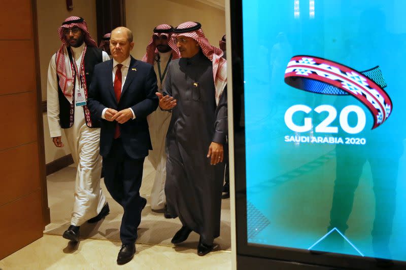 German FM Scholz and Saudi FM al-Jadaan walk to the meeting hall in Riyadh