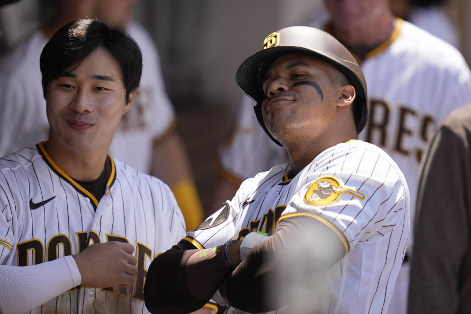San Diego Padres' Juan Soto, right, poses for a photo with teammate Ha-Seong Kim after hitting a home run during the fourth inning of a baseball game against the Atlanta Braves, Wednesday, April 19, 2023, in San Diego. (AP Photo/Gregory Bull)