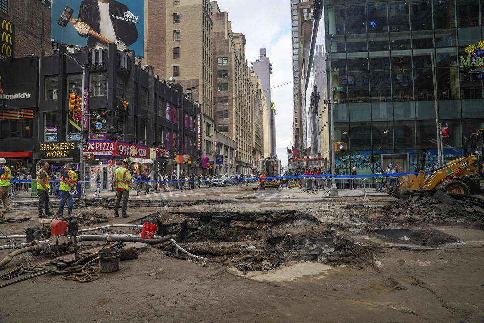 Work crews begin repair after a 127-year-old water main under New York's Times Square gave way under 40th Street and Seventh Avenue at 3 a.m., flooding streets and subways, Tuesday Aug. 29, 2023, in New York. (AP Photo/Bebeto Matthews)
