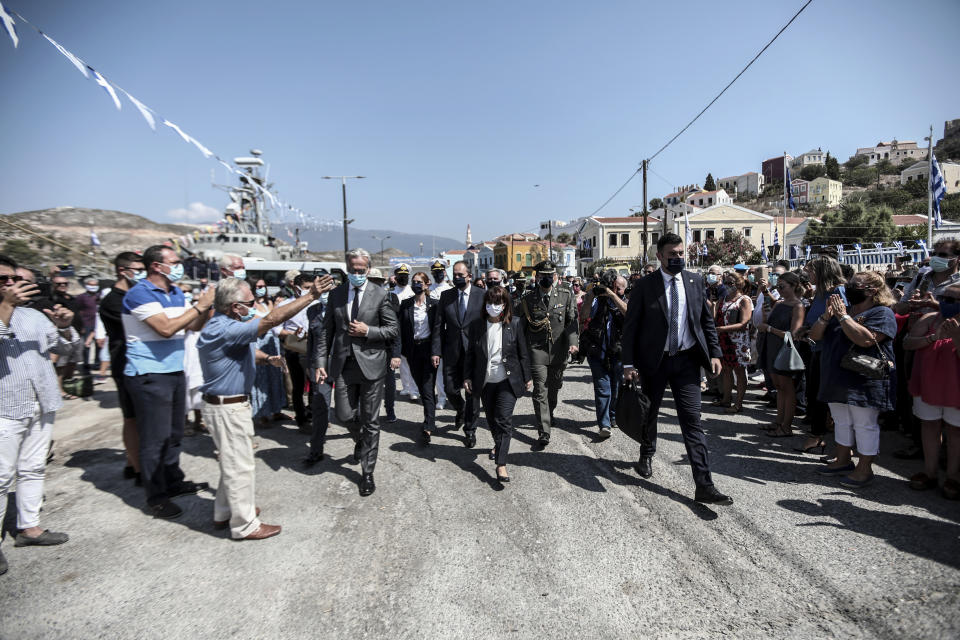 In this photo provided by the Greek President's office on Sunday, Sept. 13, 2020, Greece's President Katerina Sakellaropoulou, center, is cheered by residents during celebrations marking when the southeastern island of Kastellorizo, formally became part of Greece. Greece's prime minister outlined plans Saturday to upgrade the country's defense capabilities, including purchasing new fighter planes, frigates, helicopters and weapons systems amid heightened tensions with Turkey over rights to resources in the eastern Mediterranean. (Theodore Manolopoulos/Presidency of Hellenic Republic via AP)