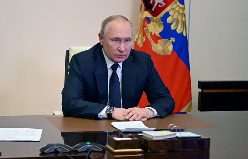 FILE PHOTO: Russian President Putin chairs a meeting with members of the Security Council outside Moscow