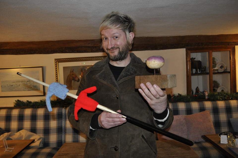 The winning artist, known only as Lie Instate, with his masterpiece and the Turnip Prize (Trevor Prideaux/PA) 