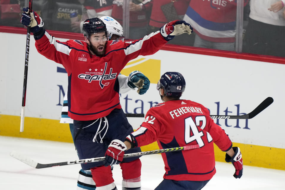 Washington Capitals right wing Tom Wilson (43) celebrates with defenseman Martin Fehervary (42) after scoring against the San Jose Sharks in the third period of an NHL hockey game, Sunday, Oct. 29, 2023, in Washington. (AP Photo/Mark Schiefelbein)