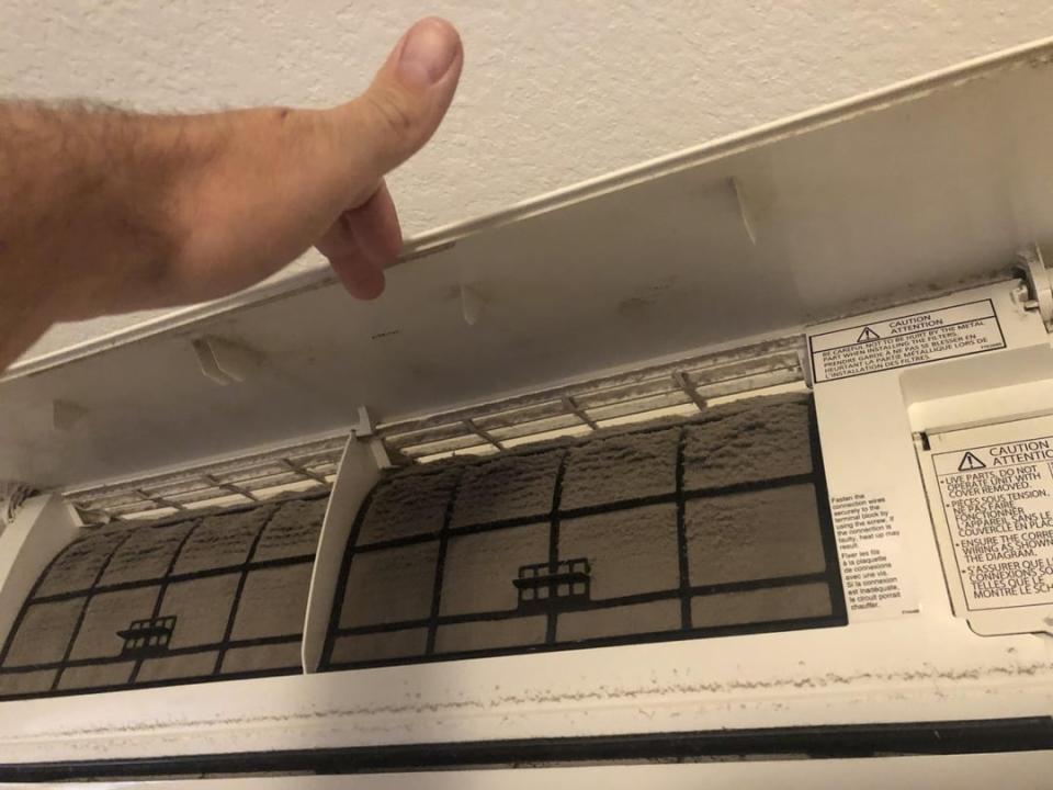 Person giving a thumbs up to a clean air conditioning filter