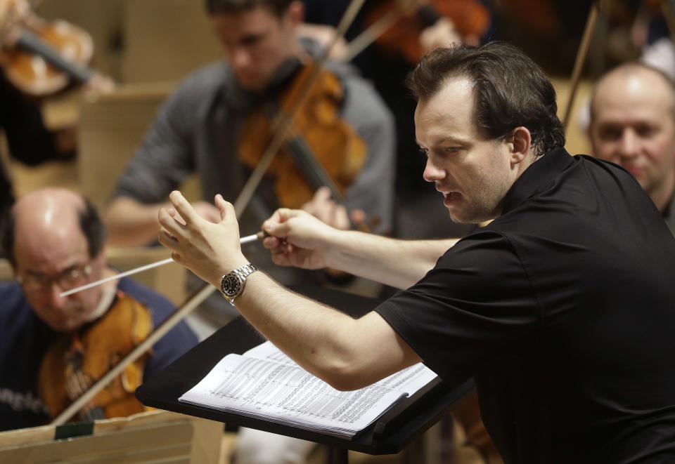 FILE- In this Nov. 20, 2014 file photo, Boston Symphony Orchestra music director Andris Nelsons rehearses at Symphony Hall, in Boston. Nelsons has reached agreement on contract extensions with both the Boston Symphony Orchestra and the Gewandhausorchester of Leipzig, Germany, the parties announced on Monday, Oct. 5. With the three-year contract extension, Nelsons is to remain the BSO's music director through the the 2024-25 season. (AP Photo/Steven Senne, File)